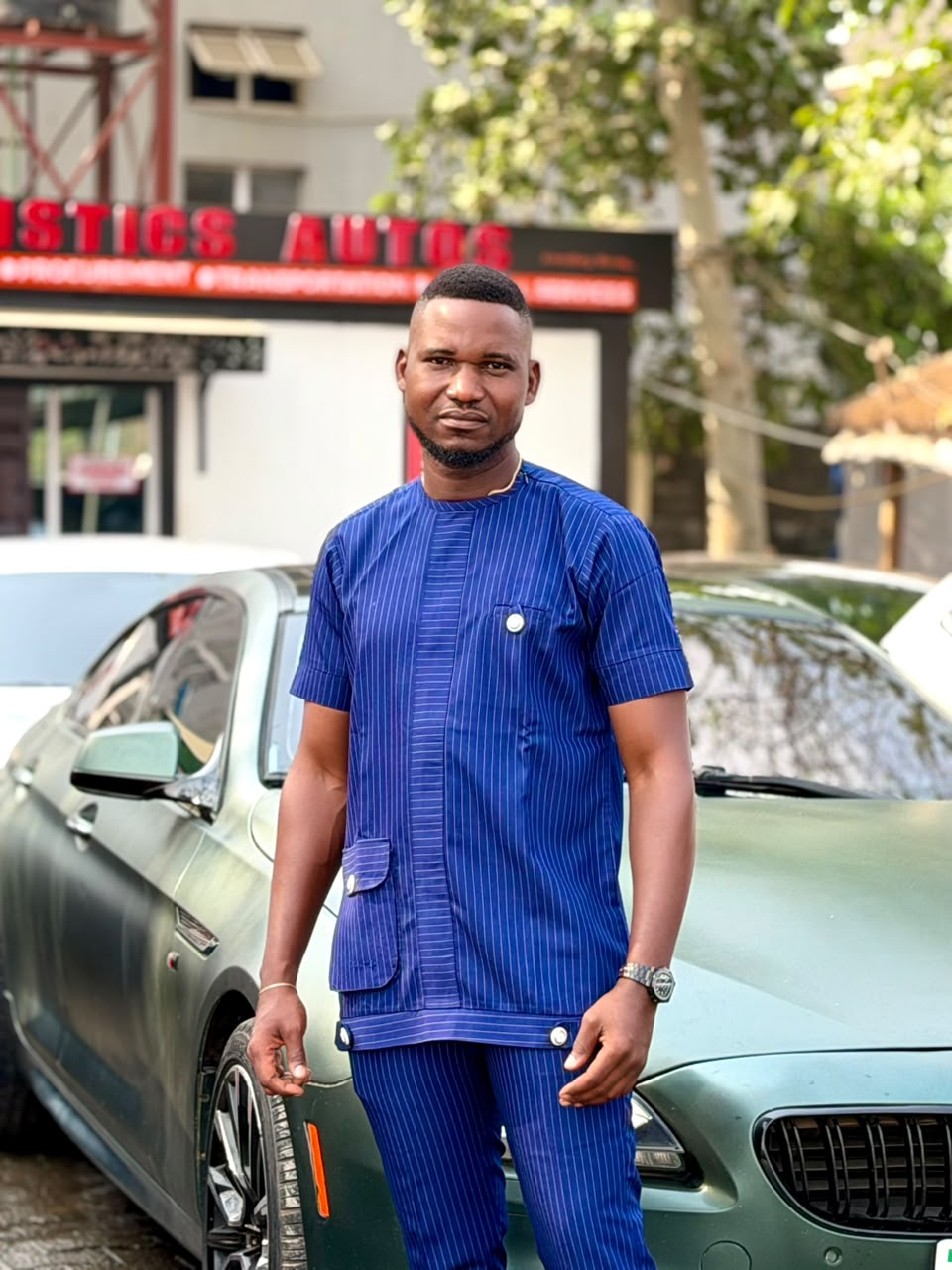 Anthony Ayodele beside a vehicle